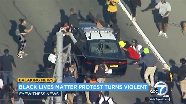 Protesters target an LAPD squad car. (Credit: ABC7)