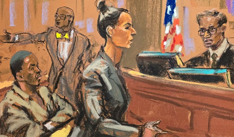 In this courtroom sketch, Assistant United States Attorney Christy Slavic, standing center, speaks during a hearing for Sean "Diddy" Combs, left, as Judge Arun Subramanian, right, presides in federal Court, Friday, Nov. 22, 2024, in New York. Attorney Tony Riccio is shown standing background center. (Jane Rosenberg/AP)