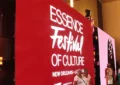 Essence Festival 2025 attendees take pictures in front of a sign. (Credit: YouTube/WWL)