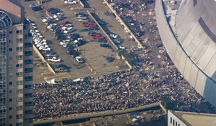 People enter the Superdome to escape Hurricane Katrina in 2005. (Credit: National Geographic)