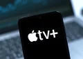 Smartphone on surface showing Apple TV+ logo — Photo by JarTee/Deposit Photos