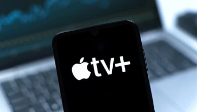 Smartphone on surface showing Apple TV+ logo — Photo by JarTee/Deposit Photos