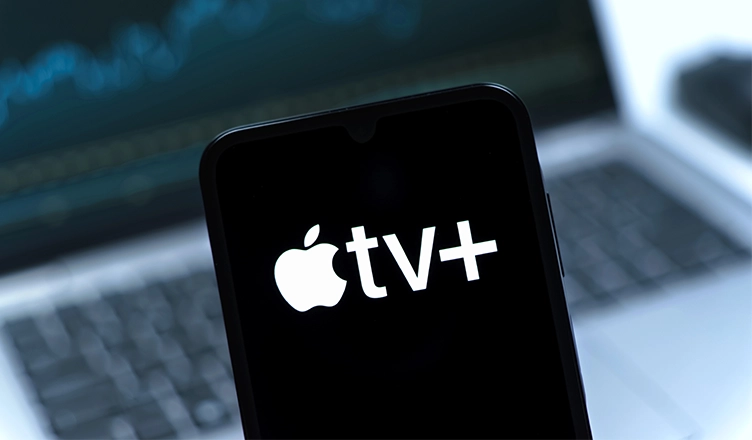 Smartphone on surface showing Apple TV+ logo — Photo by JarTee/Deposit Photos