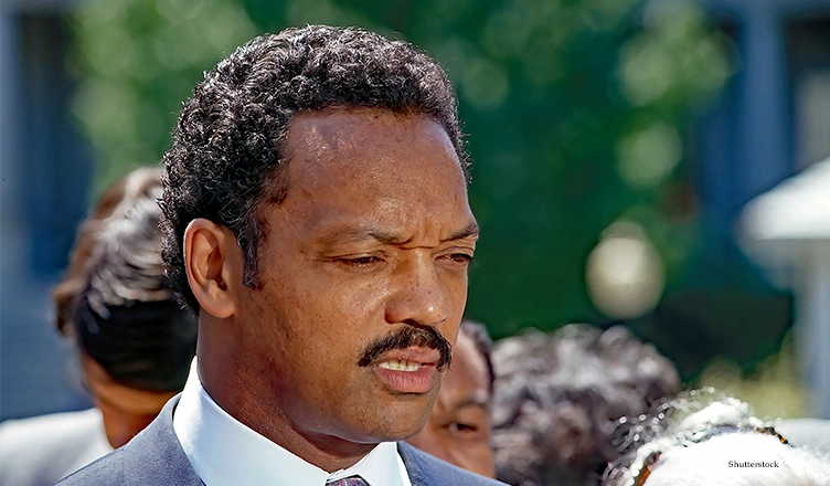 WASHINGTON DC, USA - JUNE 30, 1989 Reverend Jesse Jackson speaking to reporters in the West Wing driveway of the White House after attending the 25th anniversary event of the “Civil Rights Act” (Credit: Shutterstock)