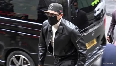 Chris Brown arrived at court in London dressed casually for the hearing in a black leather jacket, with a white turtleneck, black slacks, a baseball cap, a black face mask and dark shades on Monday, October 26, 2026. (Credit: Screengrab from YouTube/AFP)